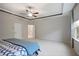 Bright primary bedroom with tray ceiling, fan, large windows, and en-suite bathroom at 100 Duval Dr, Alpharetta, GA 30009