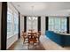 Inviting dining area with wood floors, chandelier, and large windows, adjacent to the comfortable living room at 100 Duval Dr, Alpharetta, GA 30009