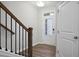 Bright entryway with wooden floors, features a staircase with black iron railings and a white front door at 100 Duval Dr, Alpharetta, GA 30009