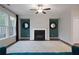 Cozy living room with fireplace flanked by decorative mirrors, complemented by hardwood floors and a plush rug at 100 Duval Dr, Alpharetta, GA 30009