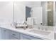 Clean, white bathroom with double sinks, shaker cabinets, a large mirror, and bright lighting at 3326 Springhaven Ave, Hapeville, GA 30354