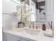 Elegant bathroom featuring a modern quartz countertop, gold fixtures, and ample natural light at 3326 Springhaven Ave, Hapeville, GA 30354