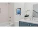 Well-lit bathroom featuring a bathtub, subway tile surround, and a vanity with a framed mirror at 3326 Springhaven Ave, Hapeville, GA 30354