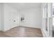 Bright bedroom with wood-look floors, a double door closet, and two windows providing natural light at 3326 Springhaven Ave, Hapeville, GA 30354