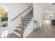 Bright hallway with wooden staircase and luxury vinyl flooring at 3326 Springhaven Ave, Hapeville, GA 30354