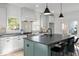 Bright kitchen with a large center island, pendant lighting, stainless steel appliances, and white cabinets at 3326 Springhaven Ave, Hapeville, GA 30354