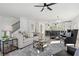 Bright living room with modern furniture, new flooring, and an open floor plan leading to the kitchen at 3326 Springhaven Ave, Hapeville, GA 30354