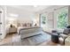 Serene main bedroom with two large windows, neutral décor, a sitting area, and hardwood flooring at 3326 Springhaven Ave, Hapeville, GA 30354