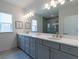 Bathroom featuring double vanity, gray cabinets, quartz countertop, large mirror, and stylish light fixtures at 4374 Benfield Se Way # 1801Lo, Smyrna, GA 30080