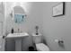 Powder room featuring a pedestal sink, round mirror, and modern white tile at 4374 Benfield Se Way # 1801Lo, Smyrna, GA 30080