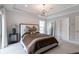 Well-lit bedroom featuring a tray ceiling, neutral tones, and a leaning mirror at 4374 Benfield Se Way # 1801Lo, Smyrna, GA 30080