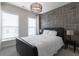 Bedroom with decorative gray paneled wall, modern lighting and neutral carpet at 4374 Benfield Se Way # 1801Lo, Smyrna, GA 30080