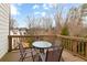 Outdoor wooden deck with a table, four chairs, and a view of the surrounding trees and neighborhood at 4374 Benfield Se Way # 1801Lo, Smyrna, GA 30080