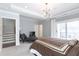 This main bedroom features stairs, a comfy chair, neutral color palette and sliding glass doors at 4374 Benfield Se Way # 1801Lo, Smyrna, GA 30080