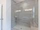 Glass enclosed shower featuring gray tiling and built in bench at 4374 Benfield Se Way # 1801Lo, Smyrna, GA 30080