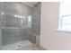 Modern walk-in shower with gray tile, a glass door, a built-in bench, and a window for natural light at 4374 Benfield Se Way # 1801Lo, Smyrna, GA 30080