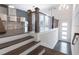 Staircase leading to the kitchen area, featuring dark hardwood floors and modern railing at 4374 Benfield Se Way # 1801Lo, Smyrna, GA 30080