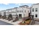 White and brick modern townhome community street view showing garage, stairs, and landscaping at 4374 Benfield Se Way # 1801Lo, Smyrna, GA 30080