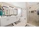 Bright bathroom with double sinks, soaking tub, and tiled walk-in shower at 565 Saint James Ct, Lawrenceville, GA 30044