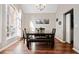 Elegant dining room featuring wood floors, a large window, and stylish furnishings at 565 Saint James Ct, Lawrenceville, GA 30044