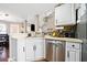 Cozy kitchen with stainless steel appliances, white cabinetry, and stylish backsplash at 565 Saint James Ct, Lawrenceville, GA 30044