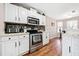 Bright kitchen with modern appliances, white cabinets, and stone backsplash at 565 Saint James Ct, Lawrenceville, GA 30044