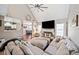 Open-concept living room featuring a fireplace, a large sectional, and hardwood floors at 565 Saint James Ct, Lawrenceville, GA 30044