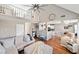 Spacious living room featuring hardwood floors, neutral paint, and plenty of natural light with sight lines into the kitchen at 565 Saint James Ct, Lawrenceville, GA 30044