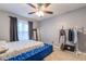 Neutral bedroom with a tufted blue bed frame, carpet flooring, and a ceiling fan at 970 Sidney Marcus Blvd # 1217, Atlanta, GA 30324