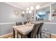 Dining room with a modern chandelier, table setting and a view of the kitchen, ready for hosting at 970 Sidney Marcus Blvd # 1217, Atlanta, GA 30324