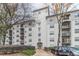 View of the apartment complex with multiple floors, balconies, beautiful trees, and landscaped areas at 970 Sidney Marcus Blvd # 1217, Atlanta, GA 30324