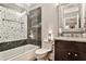 Elegant bathroom with tub-shower, mosaic tile accent wall, framed mirror, and stylish vanity at 1180 John Collier Rd, Atlanta, GA 30318