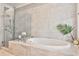 Elegant bathroom featuring a soaking tub, glass shower, and modern tile accents at 1180 John Collier Rd, Atlanta, GA 30318