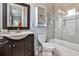 Modern bathroom featuring a tub with glass enclosure, stylish vanity, and neutral color palette at 1180 John Collier Rd, Atlanta, GA 30318