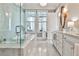 Luxurious bathroom featuring a soaking tub, marble floors, and a glass-enclosed shower at 1180 John Collier Rd, Atlanta, GA 30318