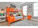 Playful ' bedroom with vibrant orange bunk beds, stylish decor, and plenty of natural light at 1180 John Collier Rd, Atlanta, GA 30318