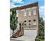 Beautiful brick townhome with attached two-car garage and landscaped entryway and stairs at 1180 John Collier Rd, Atlanta, GA 30318