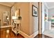 Inviting hallway with hardwood floors, console table, and a glimpse into a bright office space at 1180 John Collier Rd, Atlanta, GA 30318