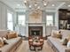 Bright living room with fireplace, modern chandelier, and stainless steel kitchen appliances at 1180 John Collier Rd, Atlanta, GA 30318