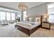 Serene main bedroom with a large bed, sitting area, and elegant lighting fixtures at 1180 John Collier Rd, Atlanta, GA 30318