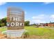 View of the 'The Works' development sign, with green space and buildings at 1180 John Collier Rd, Atlanta, GA 30318