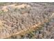 An aerial view captures a river and wooded area with a structure far off in the background at 1570 Butler Bridge Rd, Covington, GA 30016