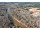 An aerial view showcases a tranquil river winding through a sprawling, wooded landscape at 1570 Butler Bridge Rd, Covington, GA 30016