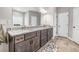 Elegant bathroom featuring double sinks, dark wood cabinetry, and neutral tones for a spa-like feel at 1570 Butler Bridge Rd, Covington, GA 30016