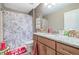 Stylish bathroom featuring granite countertop, modern fixtures, and unique shower curtain design at 1570 Butler Bridge Rd, Covington, GA 30016