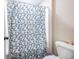 The bathroom features a shower with a decorative blue floral shower curtain at 1570 Butler Bridge Rd, Covington, GA 30016