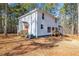 Two story home featuring a white exterior, red doors, and wooden porches at 1570 Butler Bridge Rd, Covington, GA 30016