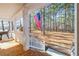 Front porch featuring an American flag and showcasing the serene and wooded surroundings at 1570 Butler Bridge Rd, Covington, GA 30016