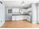 Kitchen featuring white cabinets, subway tile, and wood floors at 1570 Butler Bridge Rd, Covington, GA 30016