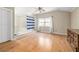 Primary bedroom with light floors, ceiling fan, large window, and bathtub in the room at 1570 Butler Bridge Rd, Covington, GA 30016